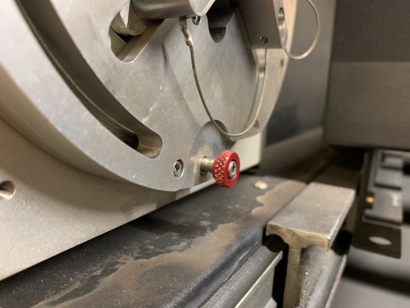 At the bottom of the chuck, there is a small pin with a red, knurled handle.  Pull the pin out until it stops.  This releases the rotary axis and allows the machine to home itself completely.