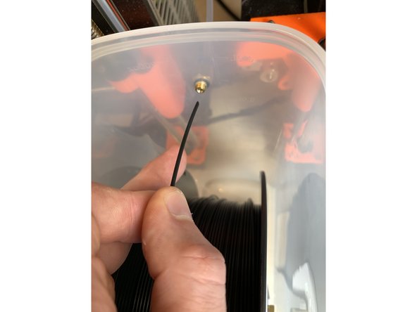 Place the reel with hub into the dry box, the brass tube in the middle of the hub will seat in the U shape at the top of the arms on the base.  Make sure the filament is directed over the top of the reel, not from underneath.