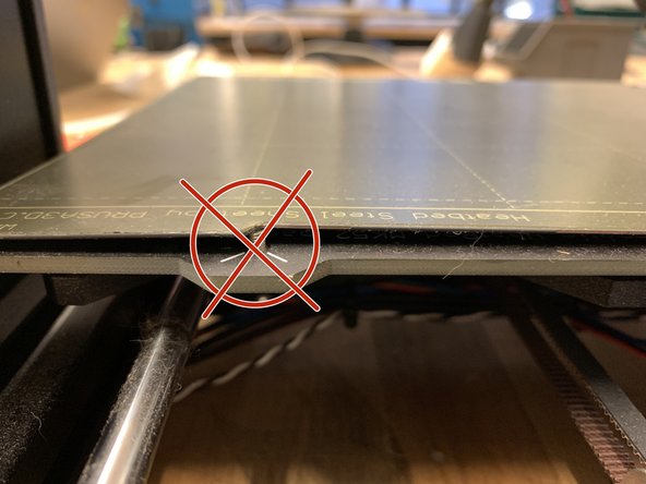 Do not use metal objects or scrapers to remove parts from the steel sheet.  The bed surface is soft and can easily be scratched or deformed.  Flatness is important to successful printing.
