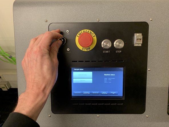 Insert the key, and turn it to the right until it stops.  It will spring back to the insertion position after turning.  The interior lights of the machine will power on and the machine will begin to initialize.