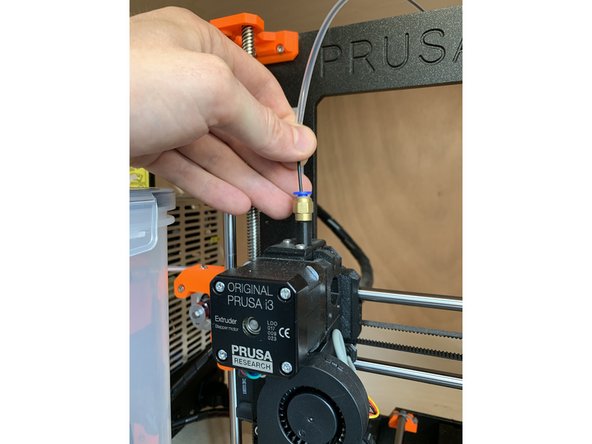 Insert the filament into the top of the extruder and feed it down until it stops at the extruder gears.