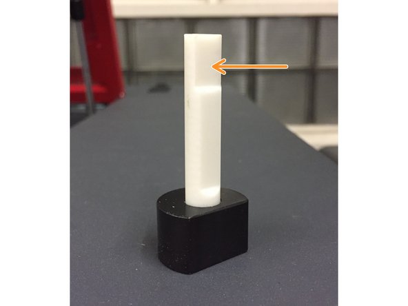 Place the flat face of the focus tool against the face of the carriage.