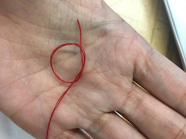 Take  both ends of your thread and line them up  together.