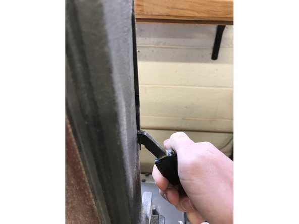 The new belt can slide on where the old one was. Once this is done, make sure to re-tension the belt by pulling the lever down.