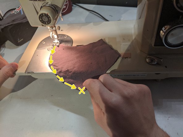 Line up all four of your layers and sew them together from the large point at the top (which will be the nose piece) down to the bottom flat edge (where your chin will go). Stop at the bottom edge but don't cut your string just yet.