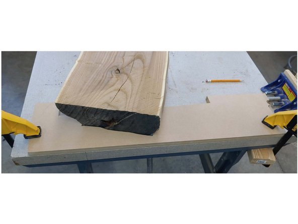 I traced the bottom of both ends of the board on a piece of MDF, and cut it out on the bandsaw. Once the board was set on the table and the fixture clamped in place the board was rock solid. Because of the shear size of this board, and the curvature I could not process it on the available machinery, so I broke out hand tools.