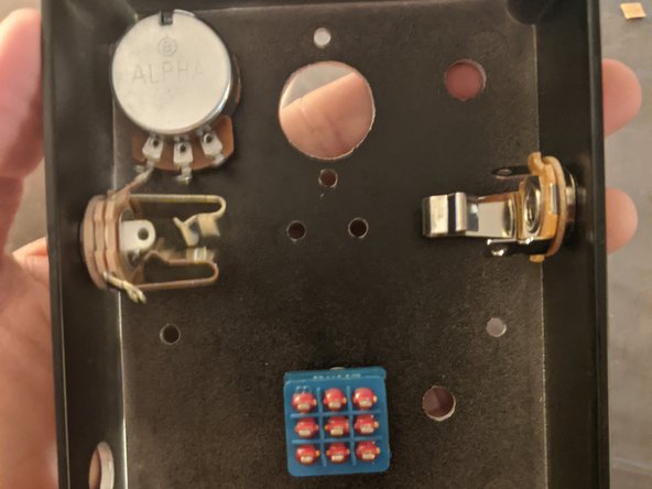 Most of the off board hardware (input/output jacks, switches, 3SPDT, potentiometers will go on with hex nuts. Remove the nut, place the component through the hole, and spin the nut back on from the outside of the enclosure.