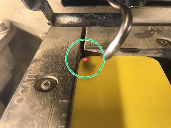 Press the red laser button to activate the laser guide.