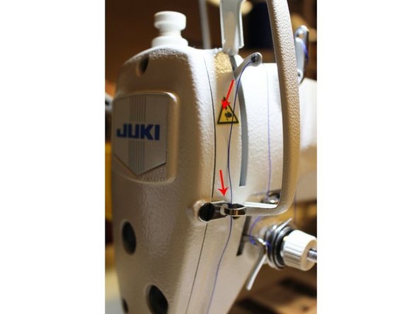 Then right below, bring the thread straight down and pull it through another silver hook.