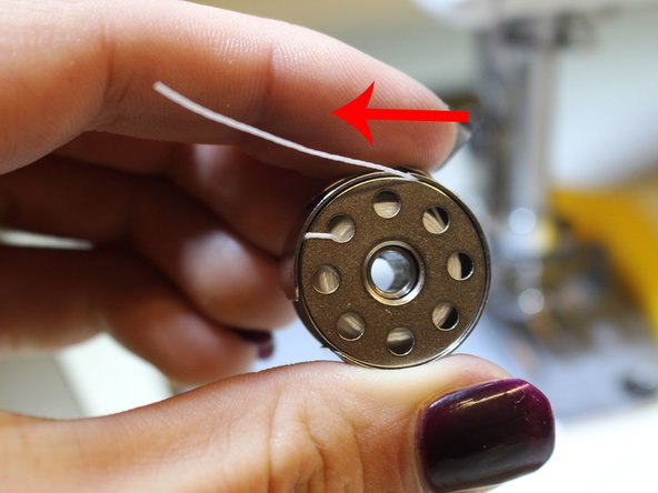 Pull thread up through the metal slit at the top of the bobbin case (A in the diagram)