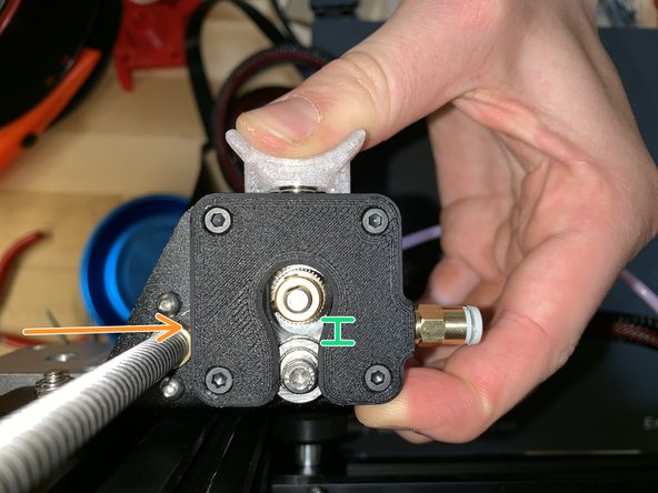 Press back on spring-loaded extruder handle.