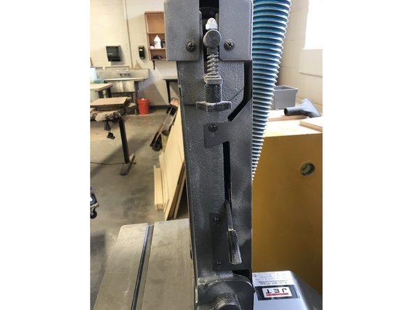 Remove the back guard off the machine by undoing the screws. There are a total of 8 screws attaching this piece, so make sure you get them all off before you try to pull the guard off.