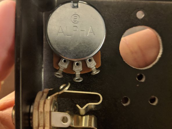 There may be a washer or rubber ring on the component, which should be installed on the inside of the enclosure touching the wall.