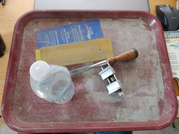 A place to work: I use a cafeteria tray I bought at a restaraunt supply place for this. It gives me a way to contain the water and grit that comes from sharpening. I set it on a bench that is a comfortable height to sit at or stand and get good leverage and body movement.