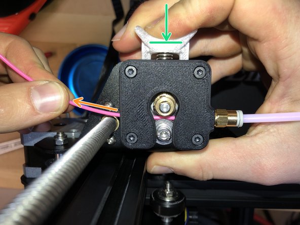 Push in on the spring-loaded extruder.