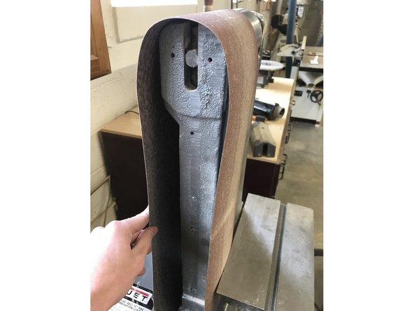 The new belt can slide on where the old one was. Once this is done, make sure to re-tension the belt by pulling the lever down.