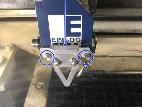Place the focus tool in between the two pins on the laser head.