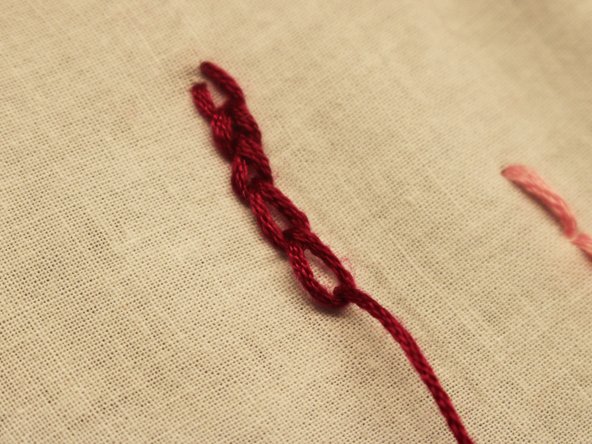 Continue to pull the needle and thread through, this will create a loop