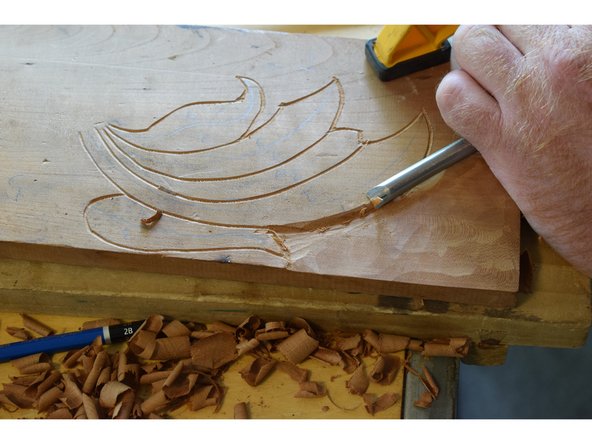 Find a gouge who's inner profile matches the shape you want, use the inner profile to round the edge how you desire.