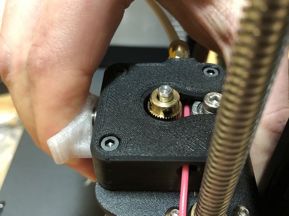 Insert filament from the left side of the extruder mount.