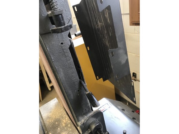 Once all screws are removed, pull the guard off the back of the machine.