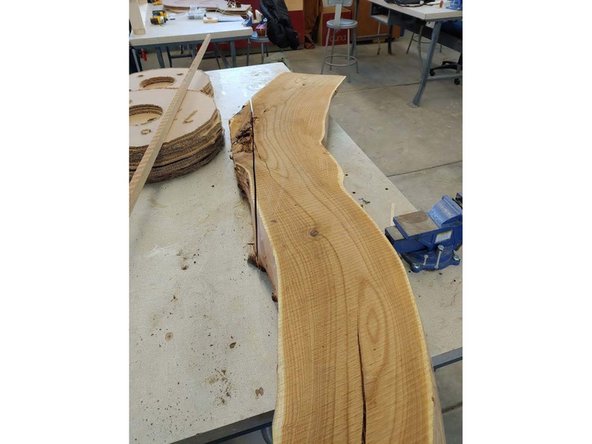 I traced the bottom of both ends of the board on a piece of MDF, and cut it out on the bandsaw. Once the board was set on the table and the fixture clamped in place the board was rock solid. Because of the shear size of this board, and the curvature I could not process it on the available machinery, so I broke out hand tools.