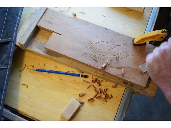 Use a broad gouge with a shallow curve and start roughing in the deepest part, in my case this is the background