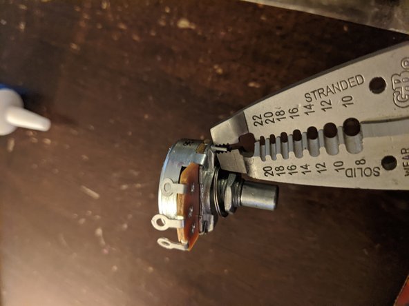 Some pots have an annoying little tab on the top of the case that will prevent it from laying flush in your pedal. Snap them off with a pair of pliers