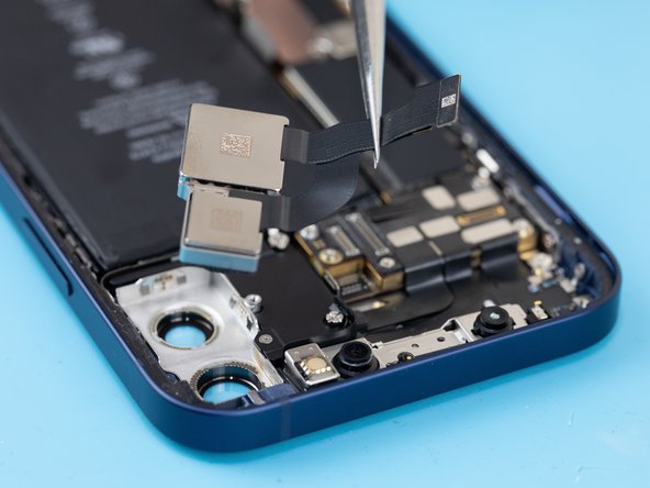 Using a spudger, pry the rear cameras out of their socket and remove them with a tweezer.