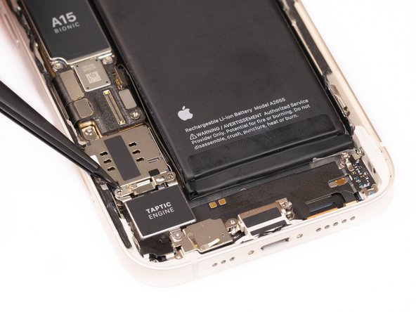 Using tweezers or your fingers, remove the remove the taptic engine cable connector bracket