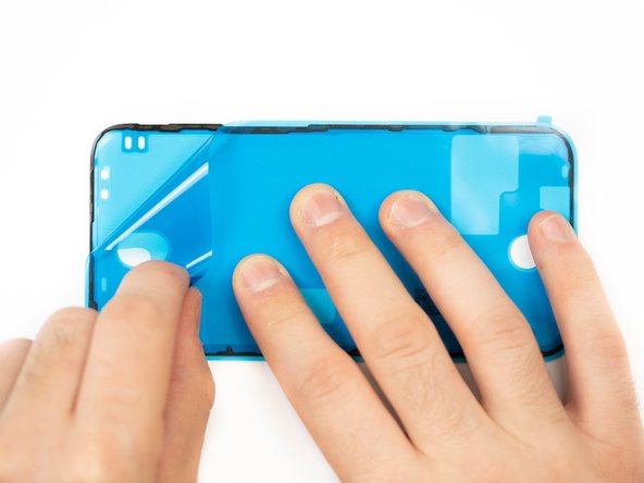 Peel away the protective cover for your adhesive. There will be a tab sticking out, use that to pull from.