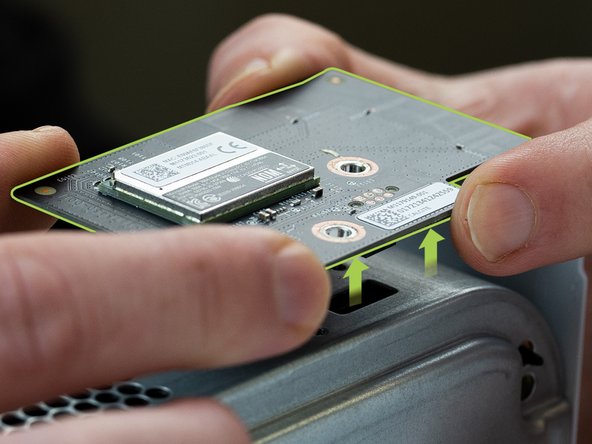 Loosen the Wi-Fi board with a spudger.