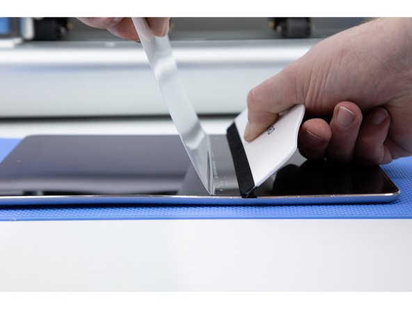 In order to succesfully stick down the larger side of your film you'll need to peel back some of the film you have just stuck down.