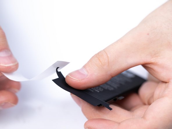 Put the second protective sticker onto the battery making sure to fold the sides.