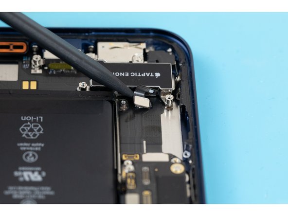 Using the tip of a spudger, pry the taptic engine cable connector out of its socket on the logic board.