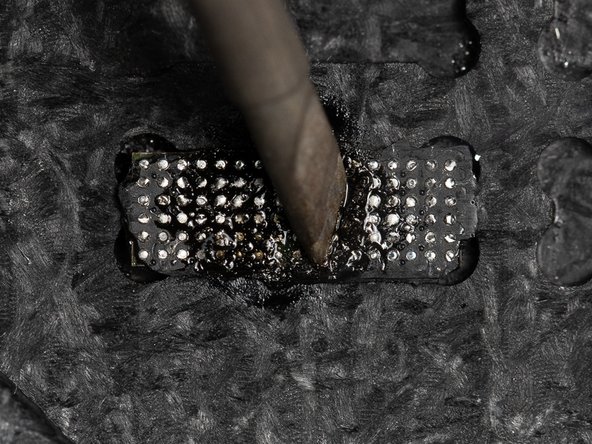 Start firmly scraping the solder iron against the chip. This will start melting the underfill glue and you'll see the glue come away from the chip.