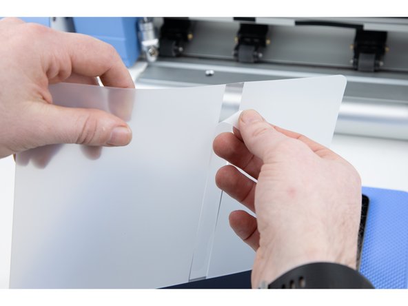 Your film will have a sticky allignment layer you'll need to peel off. This will help you stick the film down in the correct location.