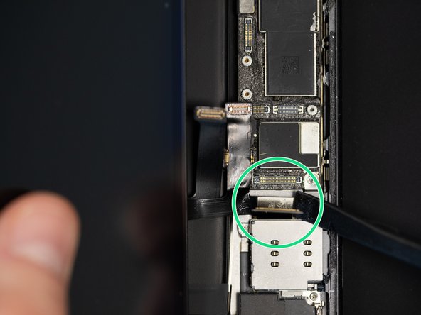 Slide the flex with the IC underneath the charging port flex.