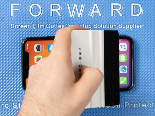 Run your application tool across the entire front film one last time to smoothe out any bubbles and ensure it's fully stuck down.