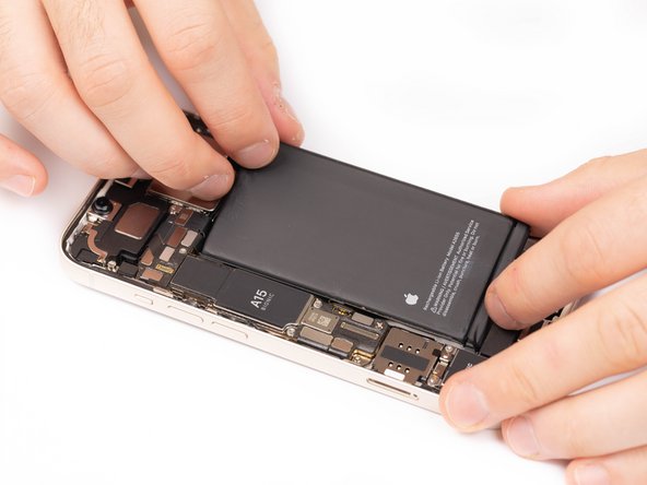Firmly press the top and bottom of the battery into place. This will help the adhesives stick to the rear case.