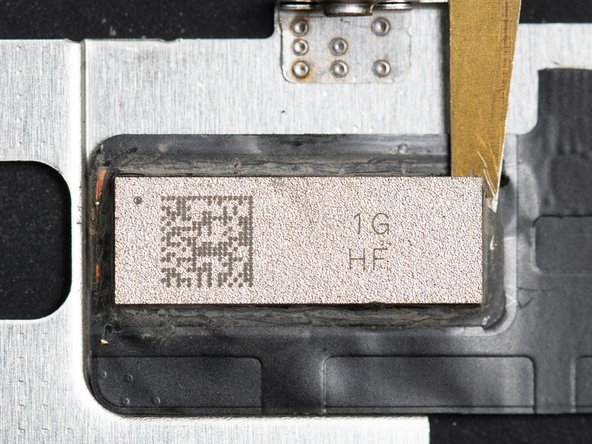 You should continue heating the chip with your hot air nozzle so the chip doesn't cool down while you're prying.