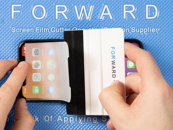 With your application tool slowly slide it along the film until you reach the top of the phone.