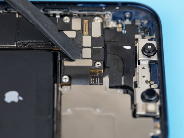 Using a spudger or your fingernail, lift the dot projector flex out from its resting socket on the logic board.