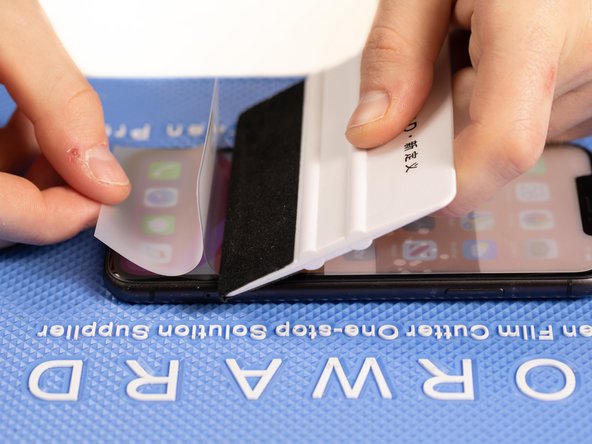 With your application tool slowly slide it along the film until you reach the end of the phone.