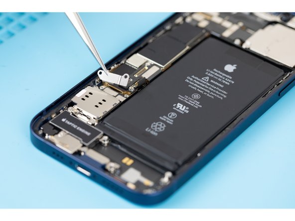 Using tweezers or your fingers, remove the Sim card reader cable connector cover.