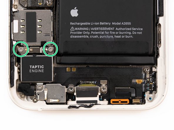 Using a screwdriver, remove two screws securing the taptic engine connector cover.