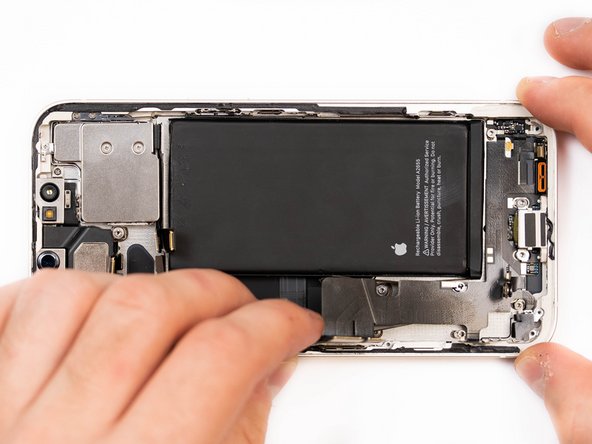 Begin prying the start of the charge port flex up with a spudger.