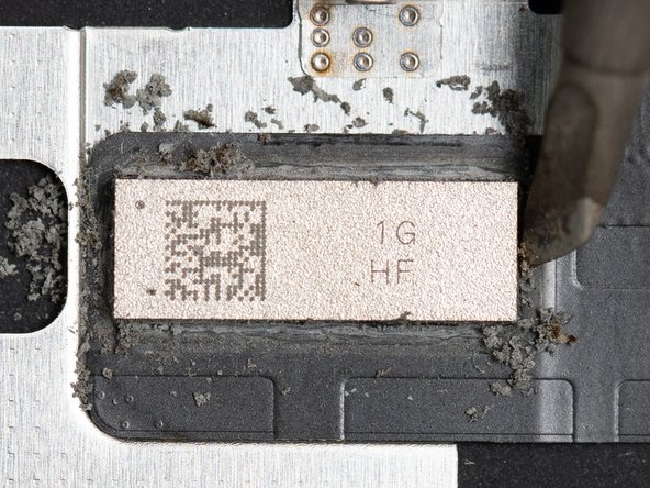 Continue cleaning all four corners of the chip until all of the glue has been removed.