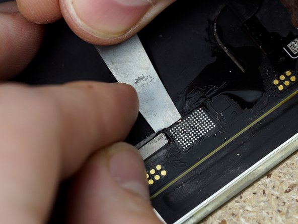 Using IPA and a spudger pry the flex away from the display, you can also put the display on a heat mat to help loosen the adhesive holding the flex down.