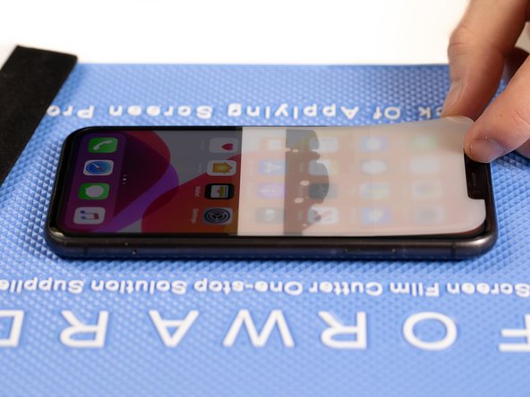 Peel the top of the front film backwards past the middle of the phone until the two layers split.